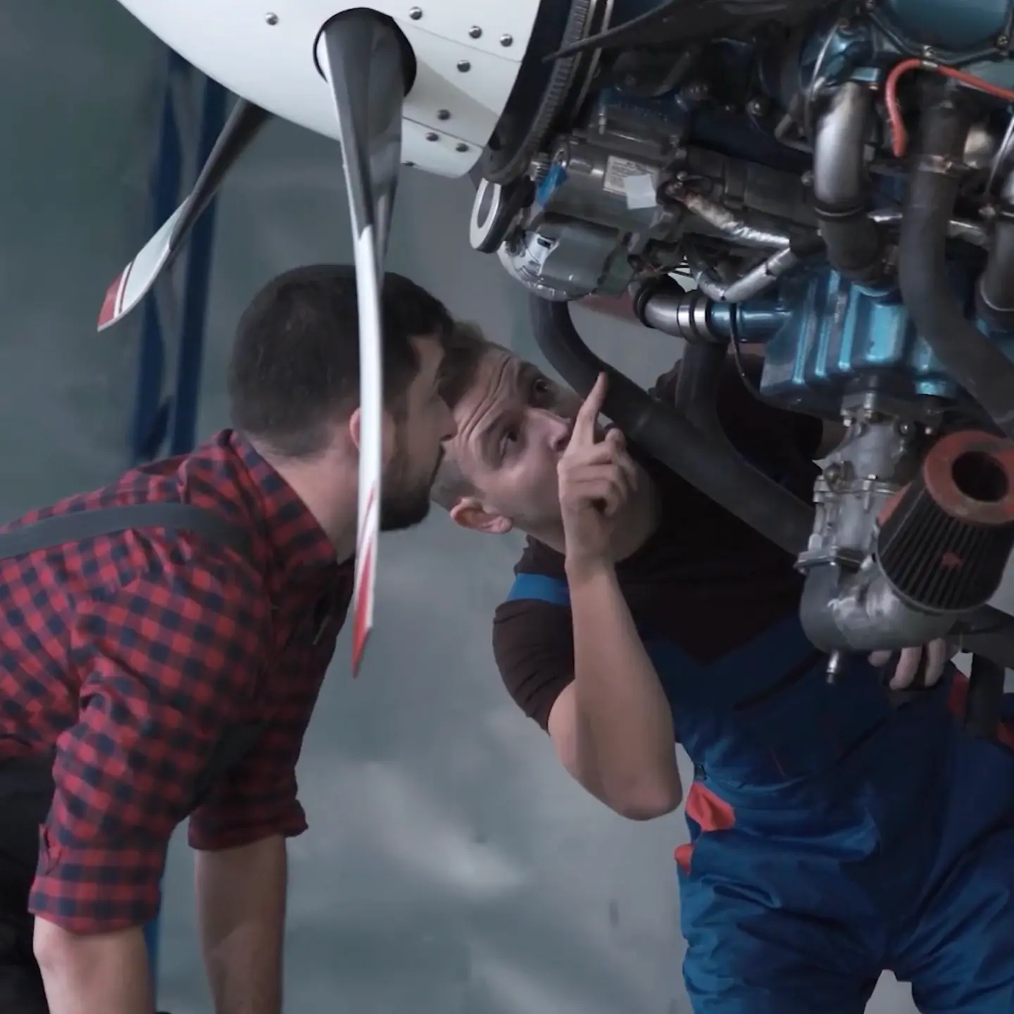 A close-up image of two men inspecting a plane engine at Northstar Technologies.